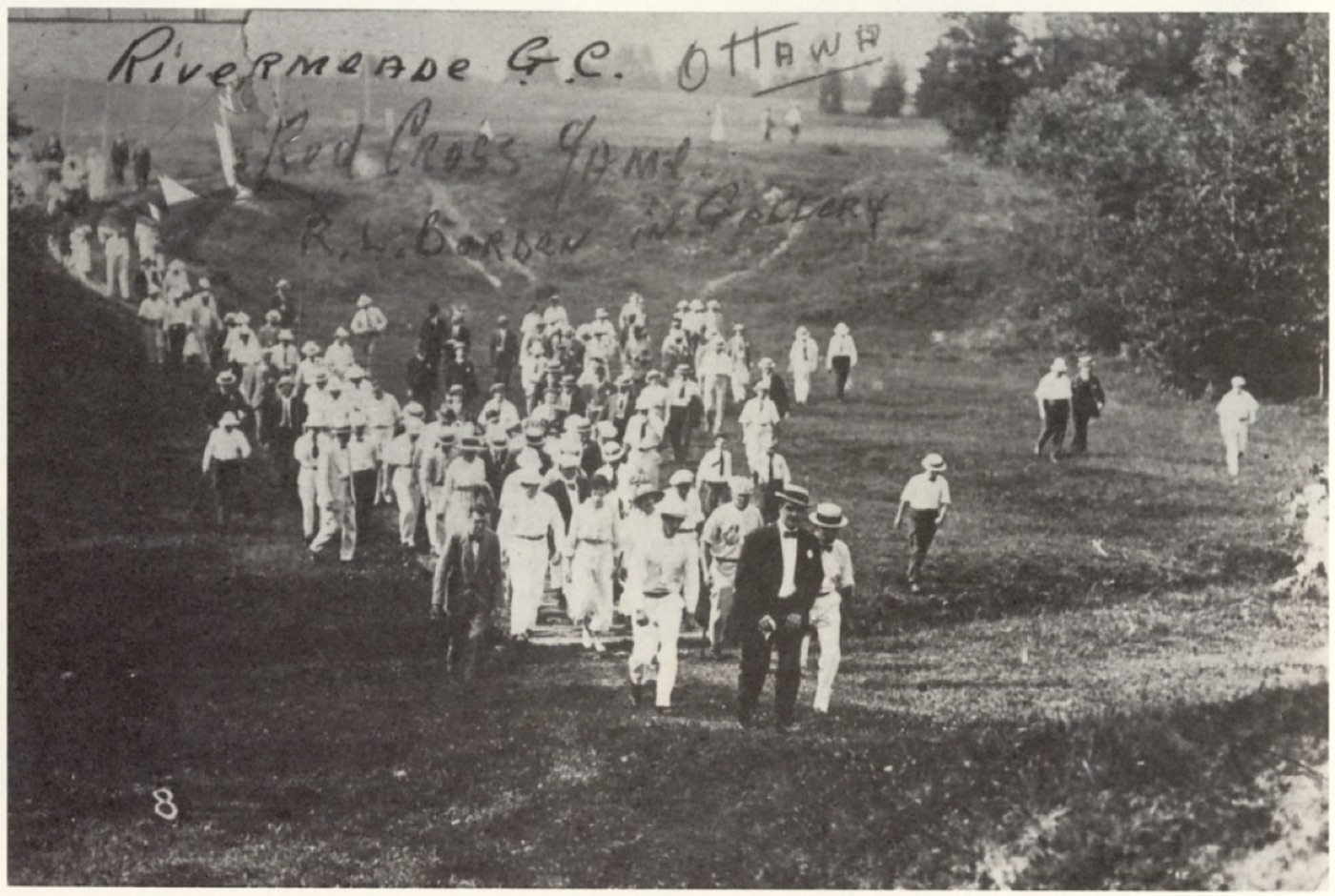 A large gallery in Edwardian dress walking the course, hand-captioned 'Red Cross Game, R.L. Borden in gallery'