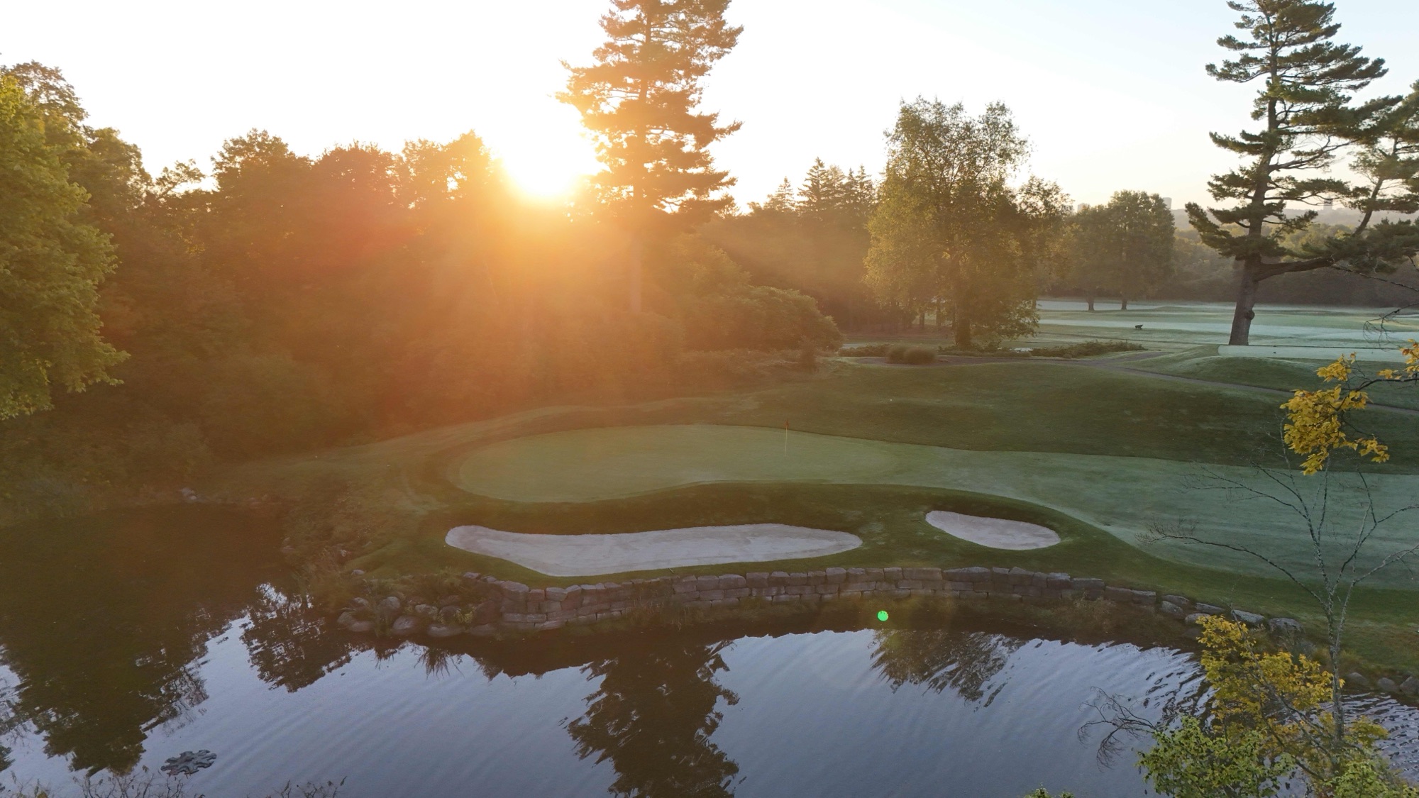 The thirteenth green and its pond seen from above